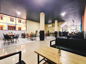 a large room with tables and chairs and a table at Tripletree Kenaro Hotel in Blimbing