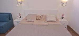 a bed with pillows on it in a room at Adela Sunset View by Blaxy Resort in Olimp