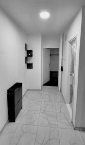 a room with a hallway with a dresser and a room with a door at Apartman City 2 With 2 Bedrooms and Free Parking in Negotin +2 photos