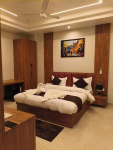 a bedroom with a large bed in a room at G RAK HOTELs in Etah +4 photos