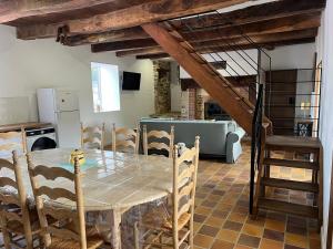 a kitchen and dining room with a table and chairs at Moulin Mossaic in Glandon