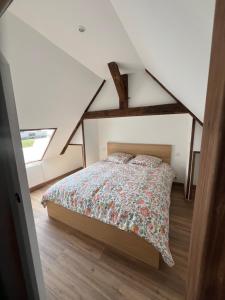 a bedroom with a bed in a attic at Moulin Mossaic in Glandon