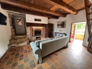 a living room with a couch and a fireplace at Moulin Mossaic in Glandon