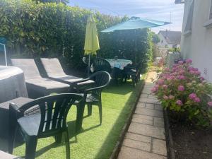 a patio with chairs and a table and an umbrella at Chambre calme Beauval Chateaux in Montrichard