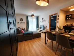 a living room with a couch and a table at FoBala Apartman in Balatonföldvár