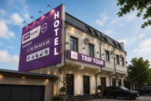 a large sign on the side of a building at TRIP Hotel in Toshkent-Passajir Bekati