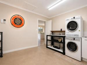 a laundry room with a washer and dryer at Pet Friendly close to Mooloolaba Sleeps 6 in Mountain Creek