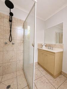 a bathroom with a shower and a sink at Pet Friendly close to Mooloolaba Sleeps 6 in Mountain Creek