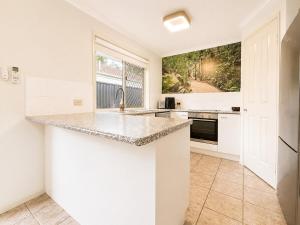 a kitchen with a counter top and a sink at Pet Friendly close to Mooloolaba Sleeps 6 in Mountain Creek
