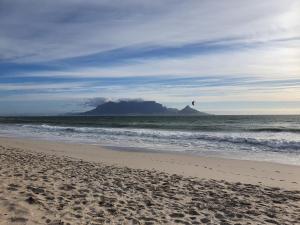 a view of a beach with a mountain in the background at Manchester Heights in Cape Town +7 photos
