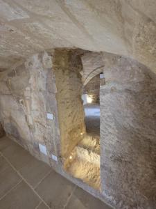 a stone archway in a stone wall in a cave at Dimora Pietra E Luce By Cala Salento in Vignacastrisi