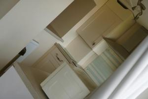 an overhead view of a kitchen with blue cabinets at Superb Cintra Beachside Apartments in Llandudno