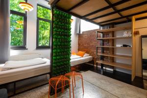 a room with two beds and a green wall at Boutique Apartments Possonium in Bratislava