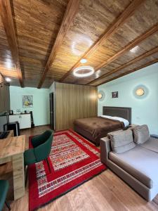 a bedroom with two beds and a table at Private in Shchūchīnsk