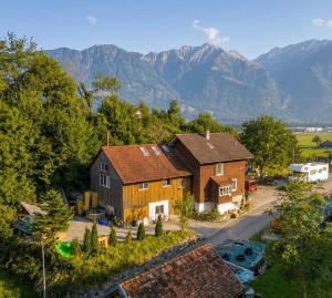 an aerial view of a house with mountains in the background at Old Farmhouse Loft near Vaduz in Sevelen