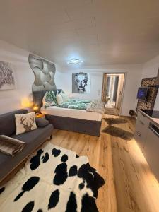 a large room with a bed and a couch at Emerald Alpine Apartment Seefeld in Seefeld in Tirol