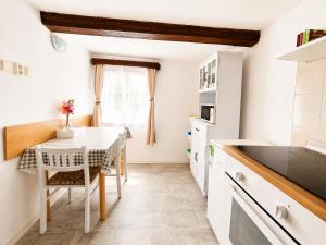 a kitchen with a table and a dining room at Apartmán Domeček u parku in Česká Lípa