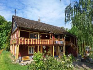 a large wooden house with a balcony on the side at Apartmán Domeček u parku in Česká Lípa