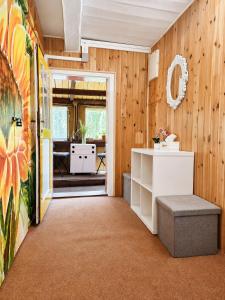 a hallway with wood paneling and a door leading to a patio at Apartmán Domeček u parku in Česká Lípa