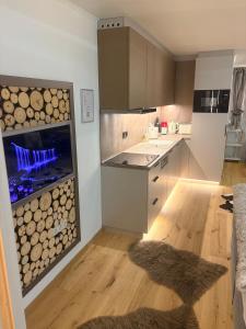a kitchen with a large aquarium with logs in it at Emerald Alpine Apartment Seefeld in Seefeld in Tirol