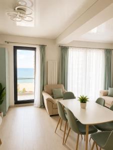 a living room with a table and a couch at HF - Mamaia Nord Building Resort in Mamaia Sat/Năvodari