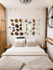 a bedroom with a bed and a wall with plates at Oaza in Bjelašnica