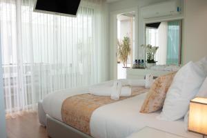 a bedroom with two beds and a large window at Luxury by the Blue in Vila Nova de Gaia
