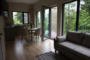 a living room with a couch and a table with chairs at Зелено Східниця in Skhidnitsa