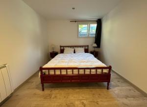 a bedroom with a bed in a room with a window at T4 avec jardin - ENVEITG in Enveitg