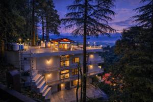 a house in the woods at night at Dalhousie Hotel in Dalhousie
