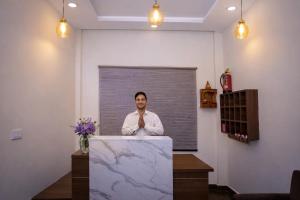 a man standing behind a podium in a room at Dalhousie Hotel in Dalhousie