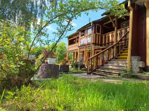 a log cabin with a porch and stairs to it at Apartmán Domeček u parku in Česká Lípa +7 photos