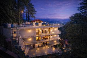 an aerial view of a building at night at Dalhousie Hotel in Dalhousie +28 photos