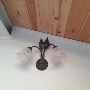 a black lamp with wings on a wall at Coccodrillo Fiorito in Viareggio +17 photos