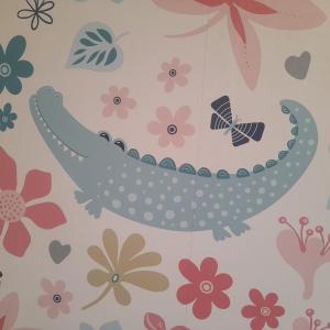 a hello kitty wallpaper with a bird and flowers at Coccodrillo Fiorito in Viareggio