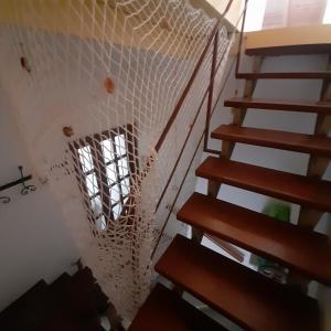 a staircase with a net on the ceiling at Coccodrillo Fiorito in Viareggio