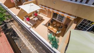 an overhead view of a restaurant with an umbrella and chairs at Primavera apartment with heated pool in Palm-Mar +36 photos
