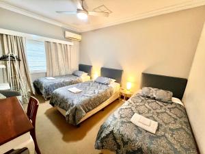 a hotel room with two beds and a table at Bõucher Manor - Northam in Northam