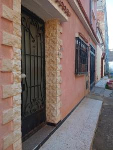 a black door on the side of a building at Oran ville in Oran