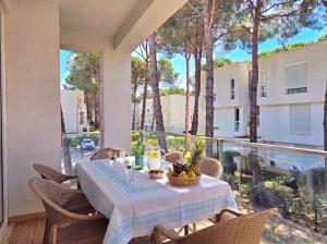 a table on a balcony with a view of a building at White Shell Apartments in Lalzit Bay