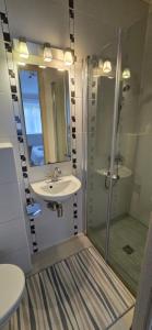 a bathroom with a sink and a shower at Apartamentai šalia baseino in Palanga +32 photos