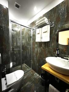 a bathroom with a sink and a toilet and a shower at Comfort Hotel in Fier +45 photos