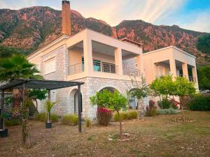 a house with a mountain in the background at Sea and Mountain View in Kalamata