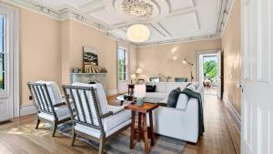 a living room with a white couch and two chairs at River View by AvantStay in Germantown