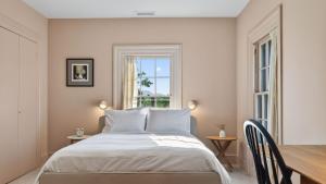 a bedroom with a bed and a table and two windows at River View by AvantStay in Germantown +58 photos