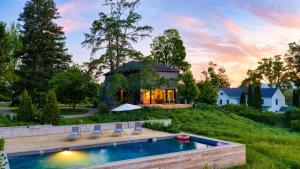 a home with a swimming pool and a house at River View by AvantStay in Germantown
