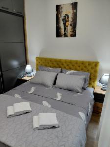 a bedroom with a bed with two towels on it at Rajsko sunce in Vrnjačka Banja