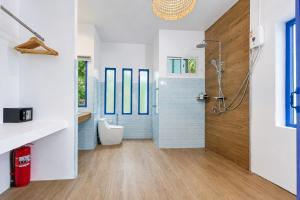 a bathroom with a shower and a toilet at Archie Village in Hinkong