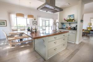 a large kitchen with a large island in the middle at Me & U - הווילה שלי בכנרת in Tel Kazir