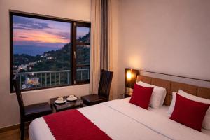 a hotel room with a bed and a large window at Dalhousie Hotel in Dalhousie